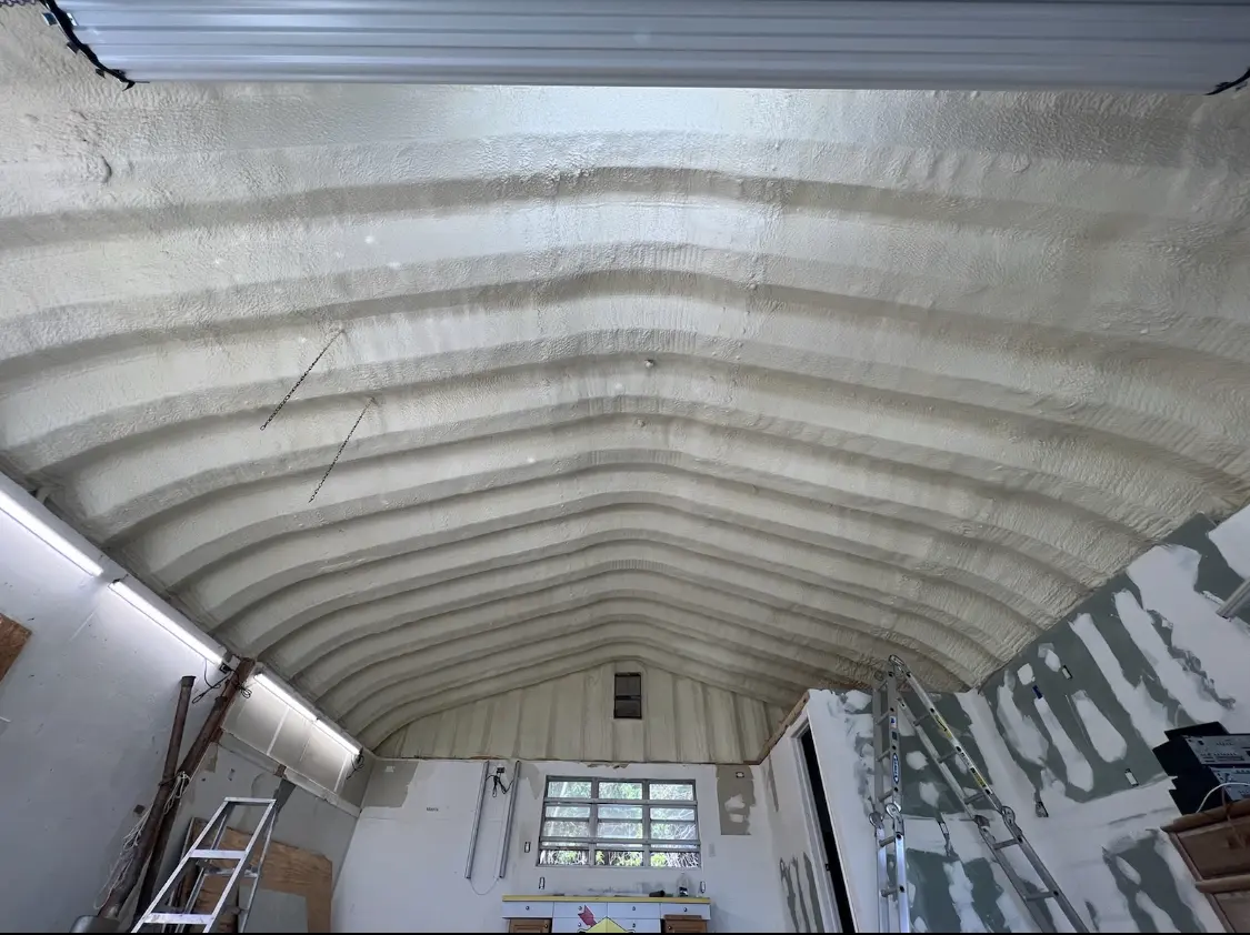 Spray polyurethane foam applied to the underside of a metal roof deck in Clermont